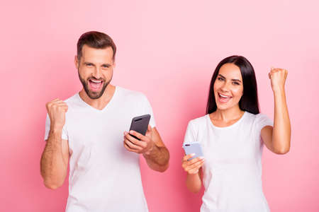 Portrait of his he her she two nice-looking attractive lovely charming cheerful cheery spouses using 5g app online internet isolated over pink pastel backgroundの写真素材
