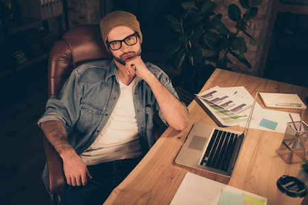 Photo of thoughtful interesting wise and intelligent financial analytic weraing brown hat cap being to analyze his company abilities in contesting with other similar companiesの写真素材