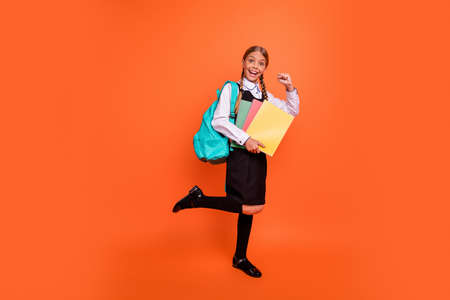 Full length body size view of her she nice attractive lovely charming cheerful cheery girlish confident pre-teen girl best course class learner isolated over bright vivid shine orange backgroundの写真素材
