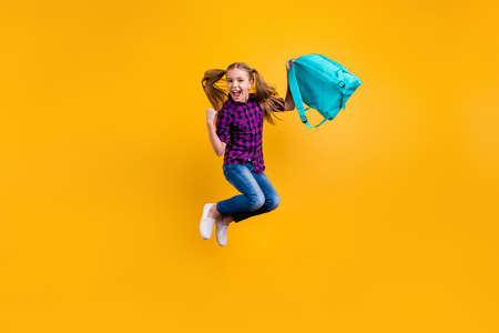 Full length photo of small pupil jump high finally holidays hooray wear casual checkered shirt jeans denim isolated yellow backgroundの写真素材