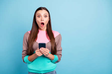 Photo of shocked lady with big staring eyes holding telephone isolated bright background
