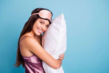 Profile side view portrait of her she nice-looking attractive lovely pretty feminine cheerful cheery girl embracing pillow late time isolated on bright vivid shine teal blue green turquoise backgroundの写真素材