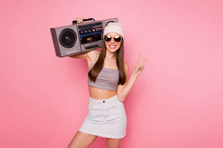 Portrait of stylish person holding boombox making v-signs having toothy smiling wearing eyewear...
