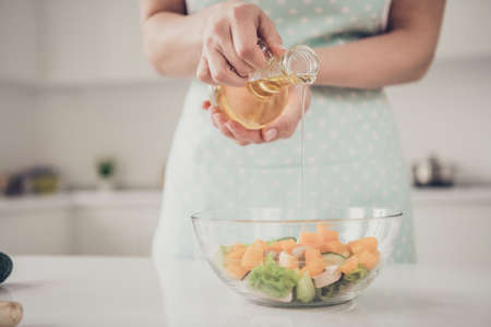 Cropped close-up view of housekeeper lady making fresh homemade domestic vegs vegan vitamin complex...