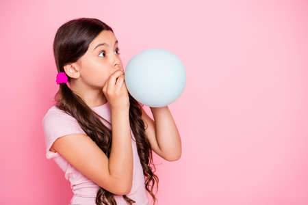 Profile side photo of cute kid hold baloon inflate look dressed white t-shirt isolated over pink...