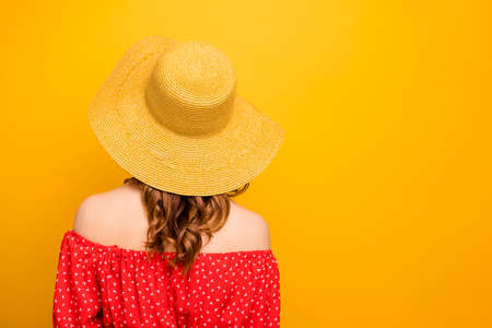 Photo of a lady wearing red dress with open shoulders isolated yellow background
