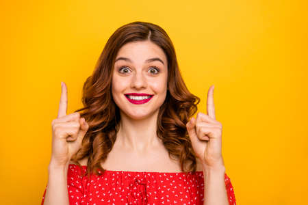 Photo of a lady wearing red dress with open shoulders isolated yellow background
