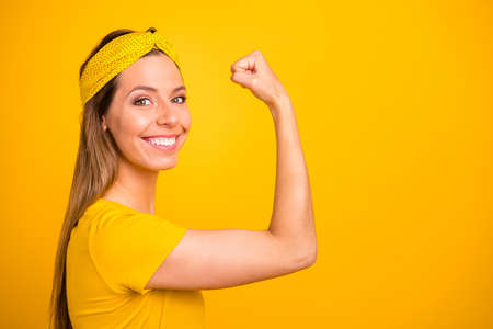 Closeup photo of beautiful lady showing perfect hand muscle wear casual t-shirt isolated yellow...