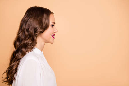 Close-up profile side view portrait of her she nice-looking attractive lovely pretty shine content cheerful cheery wavy-haired lady ceo boss chief finance top management isolated over beige backgroundの写真素材