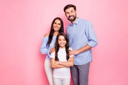 Portrait of pretty family wearing white t-shirt checkered shirt looking at camera with beaming smile isolated over pink backgroundの写真素材