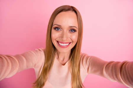 Close up photo of nice person use make photos isolated over pink backgroundの写真素材