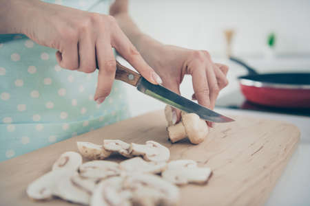 Cropped photo of woman working as cook preparing some mushroom meals for demanding clientsの写真素材