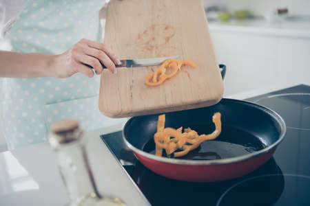 Cropped photo of housewife, cooking vegetarian dinner for her groom eating only bellsの写真素材