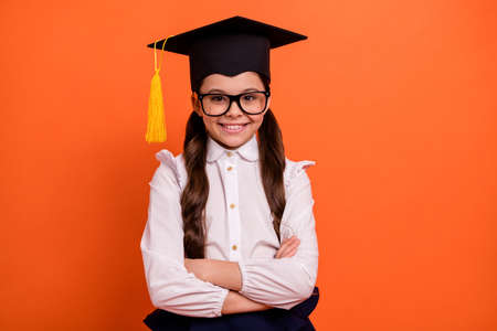 Close up photo of cute charming child masters bachelor degree concept dressed eyewear eyeglasses white modern clothing blouse prodigy isolated orange backgroundの写真素材