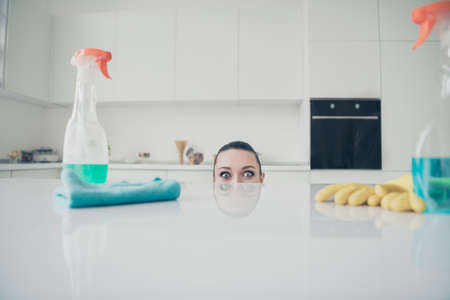 Photo of surprising girlfriend peeping out of table in order to scare you while you are walking nearbyの写真素材