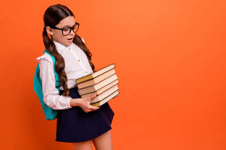 Portrait unhappy kid hold hand knowledge difficult preparation test courses eyewear, eyeglasses backpack bag rucksack white shirt blouse dress skirt isolated trendy stylish she her orange backgroundの写真素材
