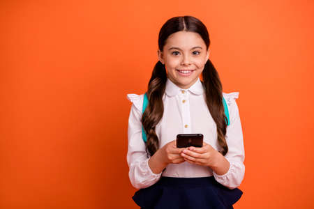 Portrait of adorable sweet little latin lady hold hand modern technology feel content school year...