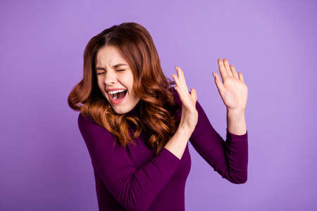 Portrait of shocked millennial raise palms shout yell isolated over purple violet background
