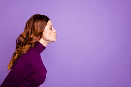 Profile side photo of cute lady youth close eyes send air kisses isolated over purple violet backgroundの写真素材