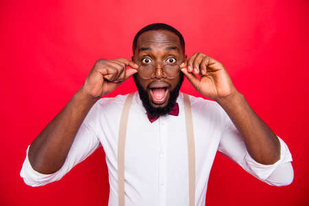 Photo of dark skin guy taking off specs not believe great sight wear white shirt isolated red...