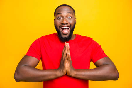 Photo of funny nice cute black man begging someone praying expecting while isolated with yellow...
