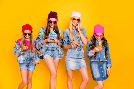 Photo of four cheerful positive flirty mother and daughter mom blonde brunette and teen babies using...
