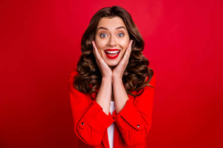 Pretty lady with open mouth hold arms on cheekbones wear formal-wear red jacket isolated burgundy...