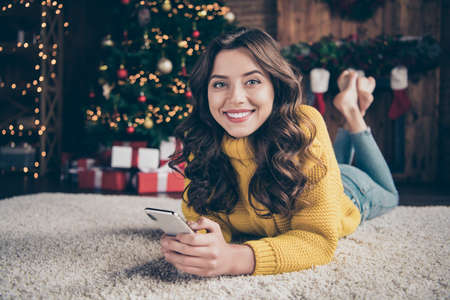 Photo of charming cute attractive gorgeous girl wearing jeans denim yellow sweater lying on floor