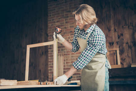 Profile side view of his he nice attractive, handsome blond serious focused skilled creative artisan...