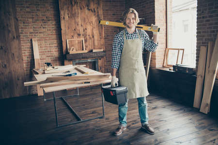 Full length body size view of his he nice, attractive handsome cheerful cheery skilled guy specialist expert carrying instruments at industrial brick loft style interior indoorsの写真素材