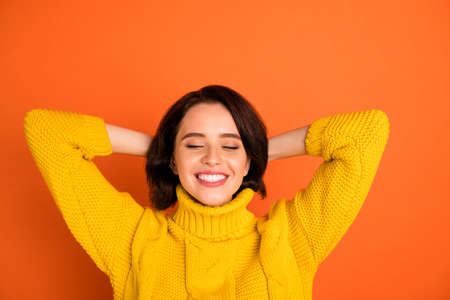 Close up photo of attractive cute, nice charming relaxing girl enjoying her vacation while isolated with orange backgroundの写真素材