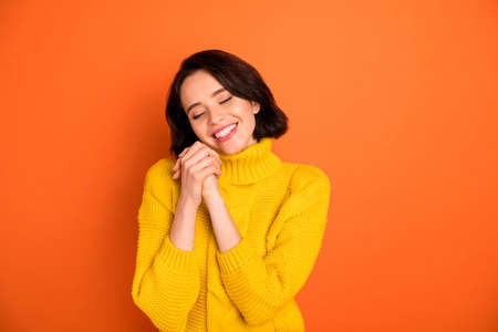 Photo of cheerful nice good friendly cute girlfriend joyful with relaxing while isolated with orange backgroundの写真素材