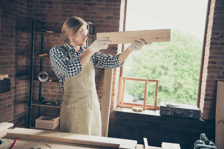 Portrait of his he nice attractive handsome blond focused guy skilled artisan builder measuring size...