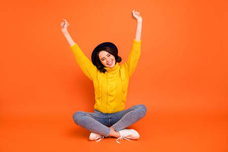 Full length body size photo of rejoicing overjoyed cheerful girl isolated over orange backgroundの写真素材