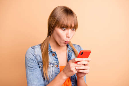 Photo of nice lady holding telephone hands reading breaking news wear casual outfit isolated beige...