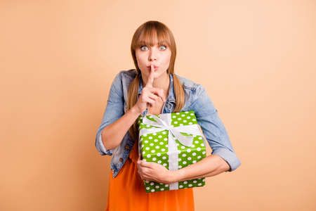 Pretty lady holding large package making surprise for mommy wear casual outfit isolated beige...