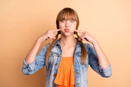Close up photo of cute pretty lovely youth millennial orange clothing she her free have weekend fool tails make face isolated beige backgroundの写真素材