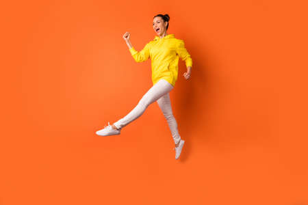 Full size photo of cute childish person moving raising legs wearing white pants trousers isolated...