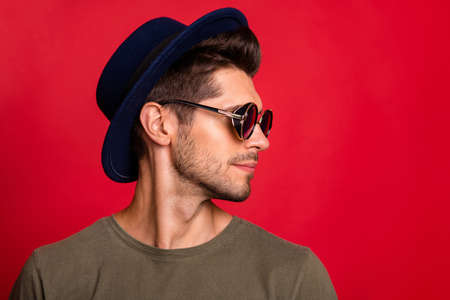 Profile photo of amazing guy wear vintage hat sun specs and grey t-shirt isolated on red backgroundの写真素材