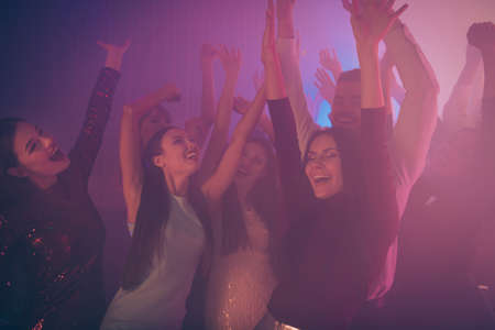 Company of nice-looking attractive smart pretty stylish glad positive excited ladies gentleman having fun rising hands up rejoicing at new cool luxurious modern bar place indoorsの写真素材