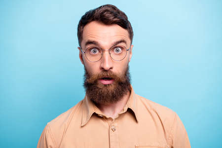 Close up photo of charming man looking wearing brown shirt isolated over blue background