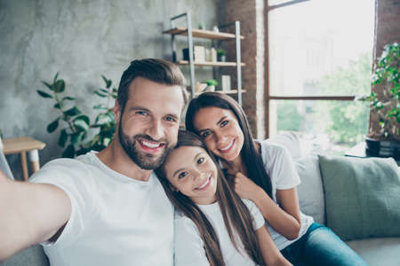 Self-portrait of nice attractive lovely sweet gentle adorable winsome charming cheerful cheery idyllic adopted foster family mommy daddy enjoying life indoorsの写真素材