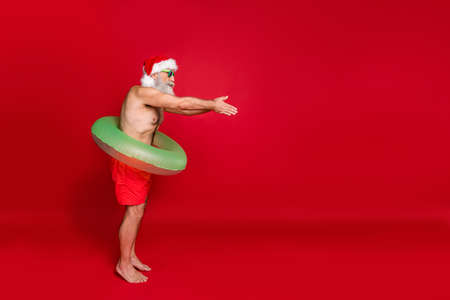 Profile side full length body size view of nice attractive funky gray-haired man enjoying summertime weekend having fun time diving poolside isolated over bright vivid shine red backgroundの写真素材