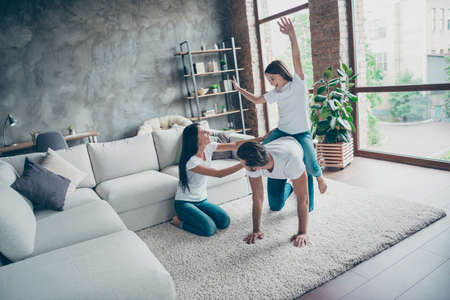 Nice attractive adorable lovely cheerful cheery family wearing casual, white t-shirts jeans fooling...