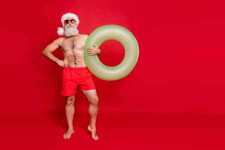 Full length body size view of his he nice attractive funky content serious gray-haired man holding in hands pond circle summertime weekend isolated over bright vivid shine red backgroundの写真素材