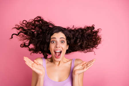 Photo of cheerful charming nice cute girl rejoicing excited with sales and discounts while isolated with pink backgroundの写真素材