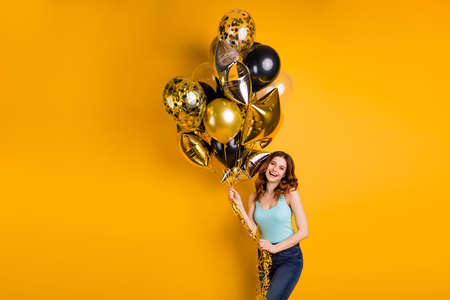 Photo of pretty lady having best bday ever with air ballons in hands wear tank-top isolated yellow backgroundの写真素材