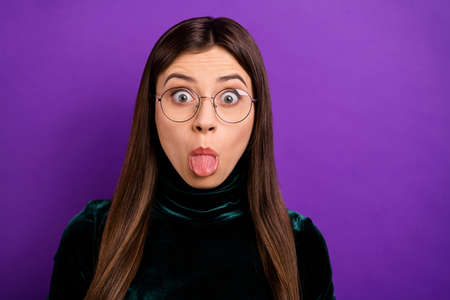 Close up photo of cute lady making faces wearing black turtleneck isolated over purple violet backgroundの写真素材