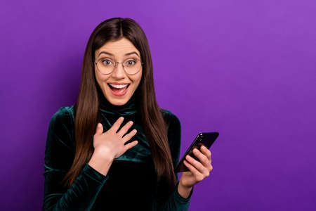 Pretty lady with telephone hands unexpected present wear green velvet turtleneck isolated violet backgroundの写真素材