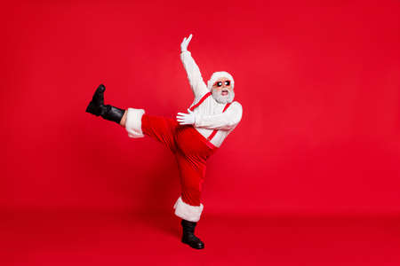 X-mas newyear time concept. Photo of overweight with round belly fatty nice positive emotional modern screaming shout singing carols grandfather moving legs hand in air isolated bright backgroundの写真素材
